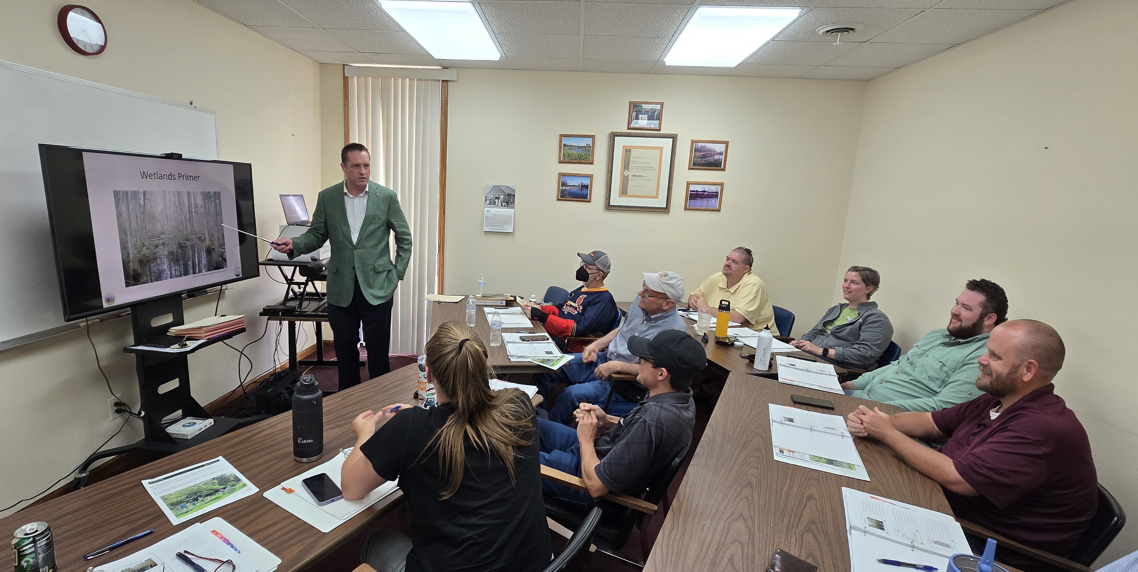 Students laugh as Frank McCoy poses for a picture before discussing Wetlands. 