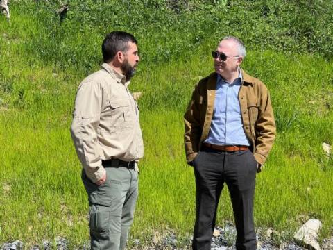 Principal Deputy Assistant Secretary for Land and Minerals Management Dr. Steve Feldgus stands to the right of a WV official in the field of Morgantown