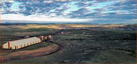 An aerial view of Spring Creek Mine area shows building infrastructure and a rolling landscape against pale blue clouded sky