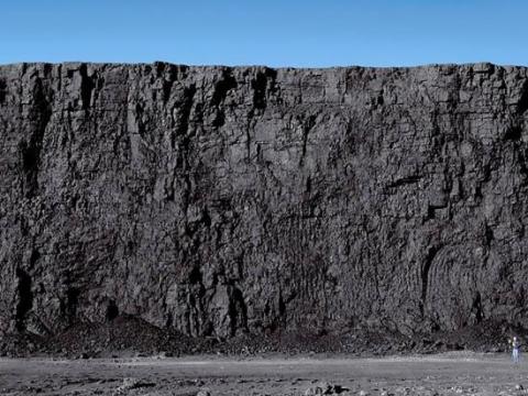 Tall ridge of grey colored rock.