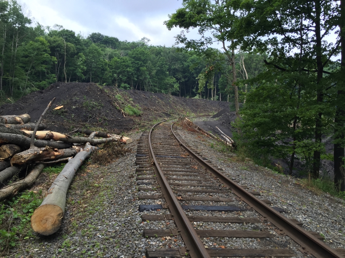 Funds are used for abandoned mine lands reclamation projects like this one in Allegany County, Maryland, that addressed a landslide blocking railroad tracks caused by coal refuse clogging a stream and culverts. Photo courtesy of Maryland Abandoned Mine Land Division.