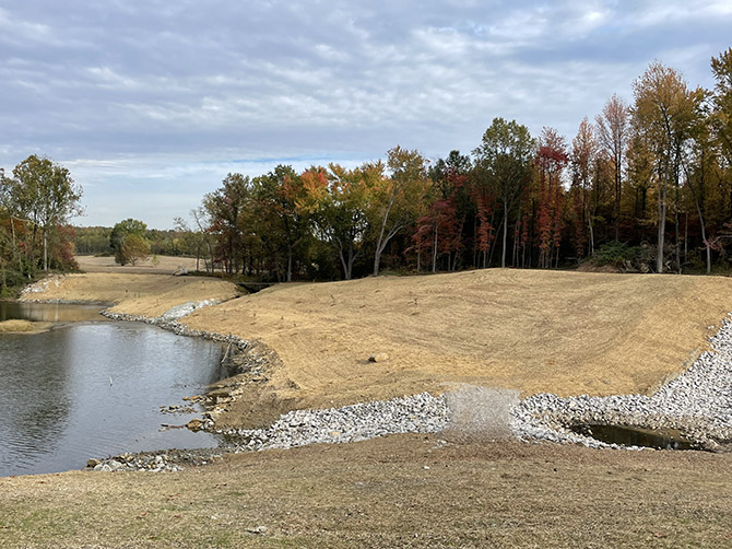 After. The dangerous highwall was replaced with a water cascade and naturalized landform, a safe swim beach, and potential for camp sites and mountain bike trails. Photo courtesy of Indiana Abandoned Mine Land Program.