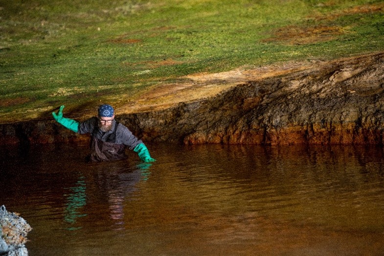 Artist John Sabraw navigates the acid mine drainage site where he and civil engineer Guy Riefler harvested the pigment for the first batch of Gamblin Artists Colors paint.  © 2018 Ohio University. All Rights Reserved/ Photo by Ben Siegel