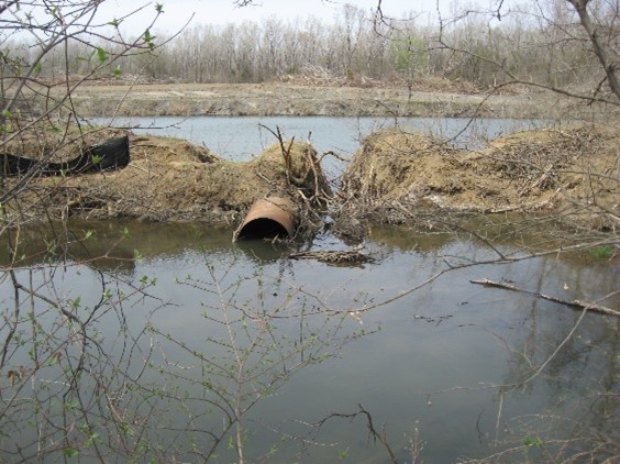 Two ponds surrounded by trees and with an old pipe in between them represent part of an abandoned mine