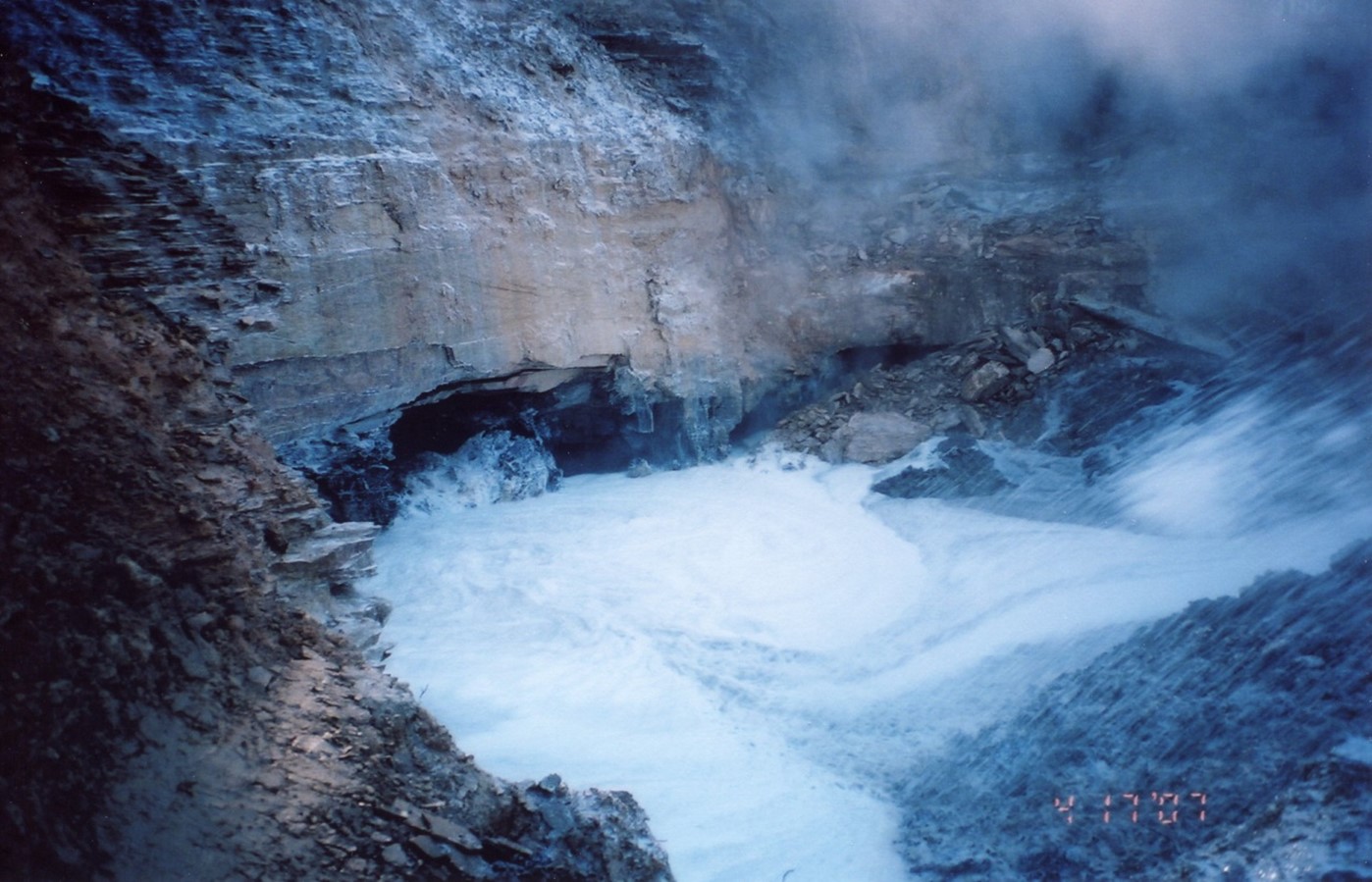This image shows large volumes of water which is pumped into a coal mine entrance.  The added water would flow down grade and allow the water to rise, extinguishing the fire as it goes.  A byproduct of this method is the development of steam within the coal mine fire area.  