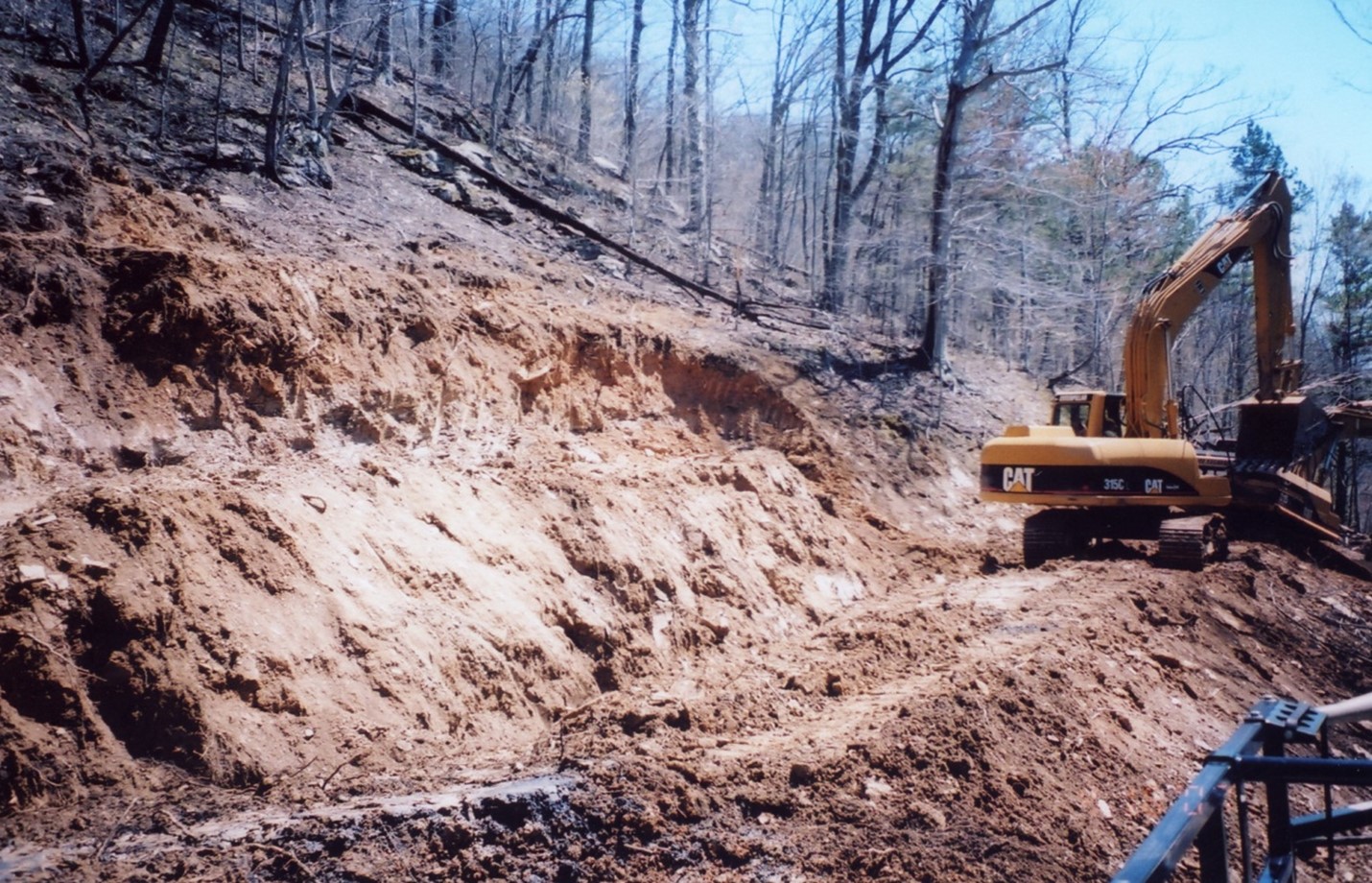 This image shown the closing of the vents in the previous picture.  The area is cleaned then backfilled with soil or other inert material.  This will block air from entering the underground mine in an attempt to limit the amount of available oxygen.
