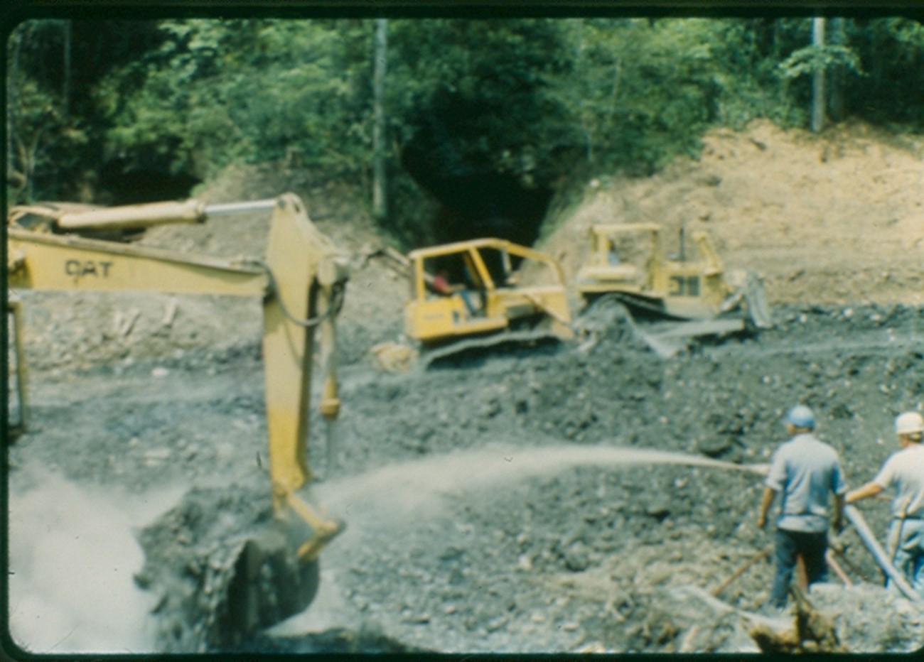 This image shows the excavation and squelching of a coal mine gob pile.  As the hot material is excavated from the ground, it is cooled with foam or water.  Then it is moved to a location where the material is allowed to cool further by spreading it out and allowing the air to cool the material.