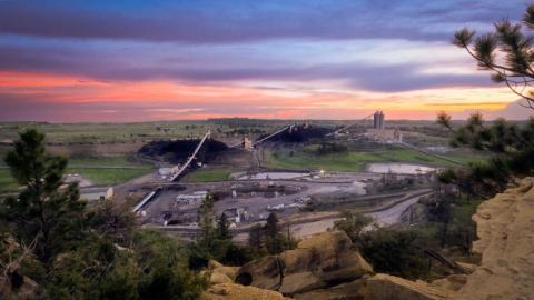 Purple and orange sunrise over mine surface facilities.